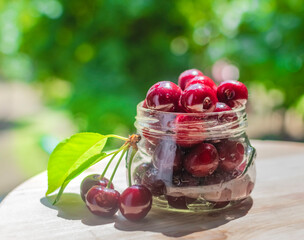 Fresh cherries in glass containers on a summer day