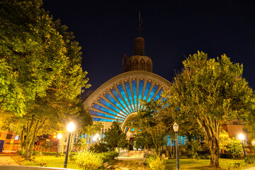 Detail of the facade of the Santana Church at night in the city of Ponta Grossa with the stained glass windows illuminated in blue