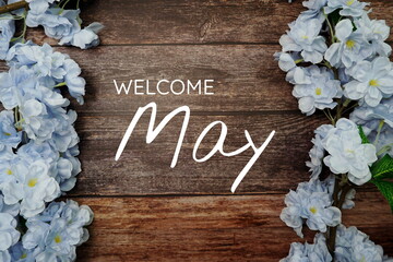Wall Mural - welcome june text and blue flower decoration on wooden background