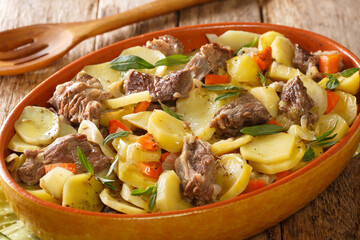 Alsace Baeckeoffe Casserole with meat, potatoes and vegetables, marinated with white wine close-up in a pot on the table. Horizontal