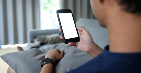 Cropped shot view of man hands holding smart phone with blank copy space screen for your text message or information content, female reading text message on cell telephone during in urban setting.