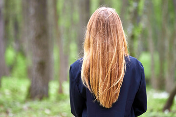 Girl with red hair on the background of nature