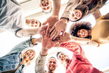 Young happy people stacking hands together outcoor - Community of multiracial international people supporting each other - Diverse culture