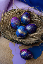 Vertical Shot Of Blue Decorated Eggs In A Nest