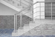 Modern Concrete Tiled Staircase Or Stairway With Stainless Steel Hand Railing At The White Wall. Front View.