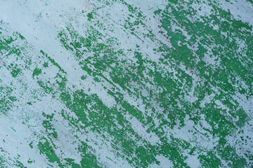 Painted in green old cracked metal rusted background. Metal texture. Erosion metal. Scratched and dirty texture on outdoor metal wall.