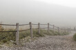 © Alexander - Foggy rocky road with wooden fences