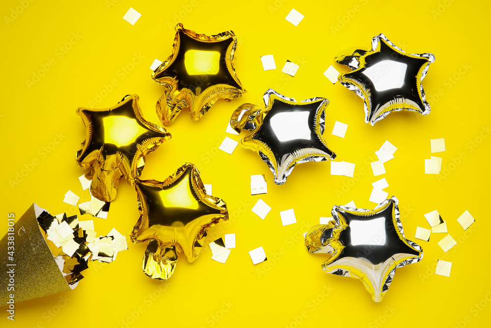 Air balloons and confetti on color background