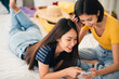 © linghaa - Young beautiful Asian couple love friend woman look at smartphone on bed at hotel room when summer trip which smiling and felling happy, LGBT woman love Travelling summer vacation trip concept