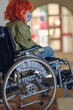 © Luka - Disabled girl with red hair wearing a mask in a wheelchair, selective focus