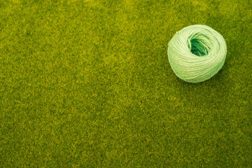 Poster - Closeup shot of a light green thread on the grass background