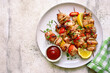 Chicken kebab skewers on a plate . Top view with copy space.