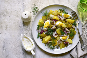 Wall Mural - Potato salad with pickled vegetables - traditional dish of german cuisine. Top view with copy space.