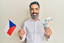 Middle Age Man With Beard And Grey Hair Holding Czech Republic Flag And Koruna Banknotes Smiling With A Happy And Cool Smile On Face. Showing Teeth.