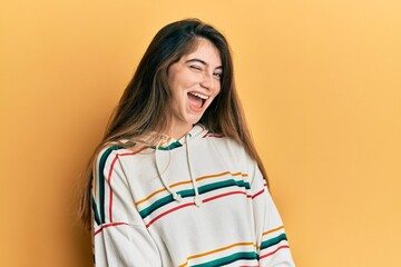 Canvas Print - Young caucasian woman wearing casual clothes winking looking at the camera with sexy expression, cheerful and happy face.