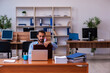 © Elnur - Young male employee working in the office