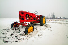 Old Red Farm Tractor On The Snow