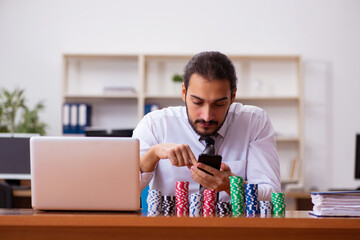 Canvas Print - Young male employee in gambling concept