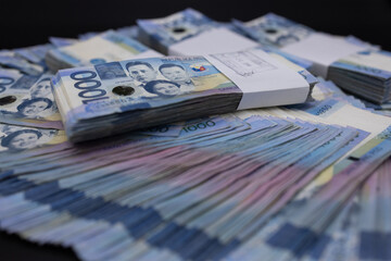 A pile of one thousand Philippines peso banknotes. Cash of Thousand dollar bills, Peso background image.