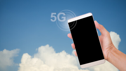 Mockup smartphone. hand holding blank screen mobile with text 5G and circle signal on blur blue sky. Future modern high speed internet network technology for business finance and lifestyle concept.