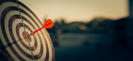 bullseye target or dart board has red dart arrow throw hitting the center of a shooting for business targeting and winning goals business concepts.