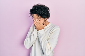 Sticker - Handsome hispanic man wearing casual white sweater with sad expression covering face with hands while crying. depression concept.