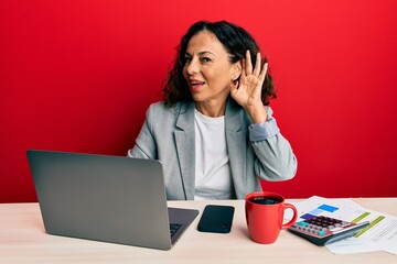 Sticker - Beautiful middle age woman working at the office drinking a cup of coffee smiling with hand over ear listening an hearing to rumor or gossip. deafness concept.