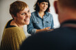 © Jacob Lund - Businesswoman smiling during a meeting in office