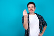 © Jihan - What the hell are you talking about. Shot of frustrated young Caucasian man with moustache gesturing with raised hand doing Italian gesture, frowning, being displeased and confused with dumb question.