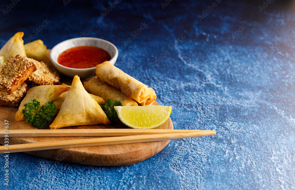 Asian finger food, Dim sum spring rolls with spicy chilli sauce on a ...