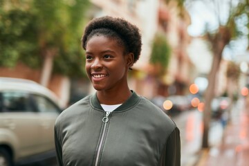 Sticker - Young african american girl smiling happy standing at the city.