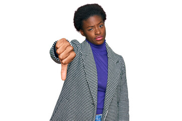 Sticker - Young african american girl wearing casual clothes looking unhappy and angry showing rejection and negative with thumbs down gesture. bad expression.