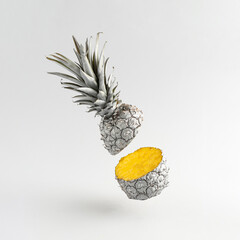 Wall Mural - Gray cut pineapple levitates above gray background. Minimal style. Creative summer or food concept.