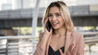 Smiling businesswoman talk on phone in city