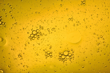 Wall Mural - light yellow liquid background of bubbles with movement