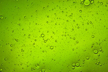 Bright Green Liquid Background Of Bubbles With Movement