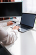 © phpetrunina14 - woman hand holding credit card and surfing on laptop white screen