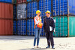 © Thirawatana - Foreman control Industrial Container Cargo freight ship. Foreman using laptop computer in the port of loading goods.