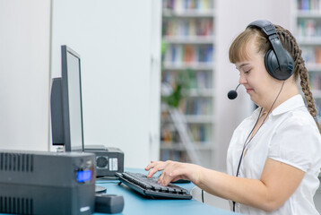 Sticker - Happy girl with syndrome down uses computer at home. Education for disabled children concept