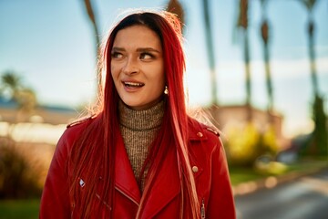 Young caucasian girl smiling happy standing at the city.