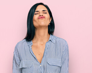 Wall Mural - Young caucasian woman wearing casual clothes looking at the camera blowing a kiss on air being lovely and sexy. love expression.