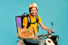 Young Courier, Pizza Delivery Man In Uniform With Thermo Backpack On A Moped Isolated On Blue Background. Fast Transport Express Home Delivery. Online Order.