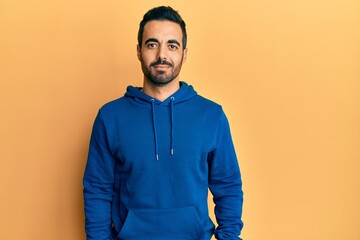 Sticker - Young hispanic man wearing casual clothes relaxed with serious expression on face. simple and natural looking at the camera.