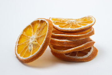 Wall Mural - Dried orange on a white background. Round slices of dried orange. Dried fruit on a light background