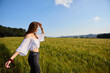 © Ekaitz - woman in a green wheat field on sunny day