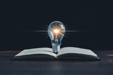 Glowing light bulb and book or text book with futuristic icon. Self learning or education knowledge and business studying concept. Idea of learning online class or e-learning at home.
