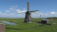 Historical Windmill In Dutch Landscape With Beautiful Clouds