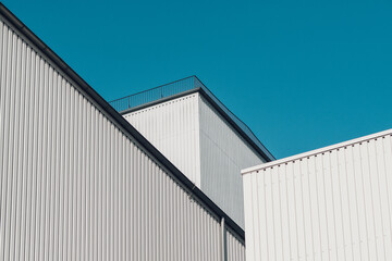 Two white Buildings and a Blue Sky