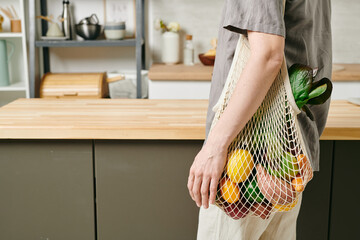 Wall Mural - Contemporary female holding bag with fruits on shoulder