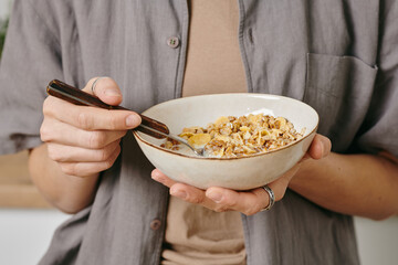 Sticker - A person holding a bowl of corn flakes during breakfast